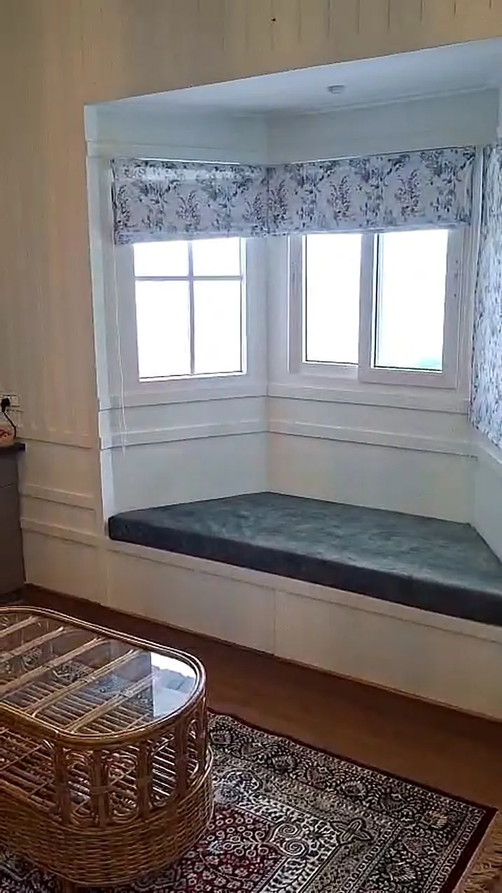 A cushioned window seat built into the bay window