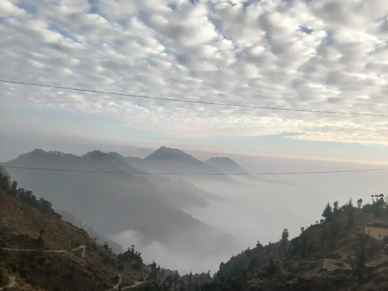 A sea of clouds in the valley at Namah Stay Himalayas, Kanatal