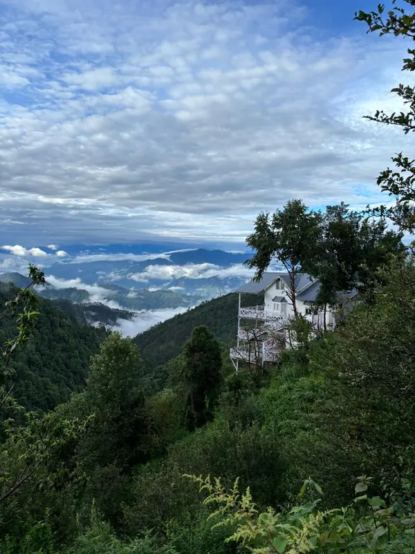 Monsoon clouds below the cottage at Namah Stay Himalayas, Kanatal