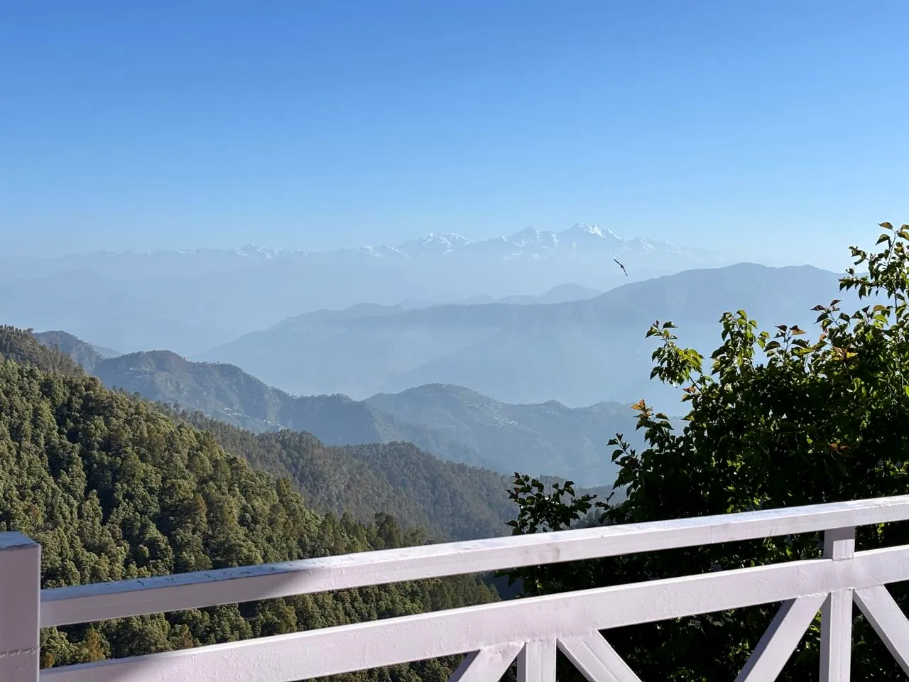 The Himalayan range seen over the white railing of the homestay deck