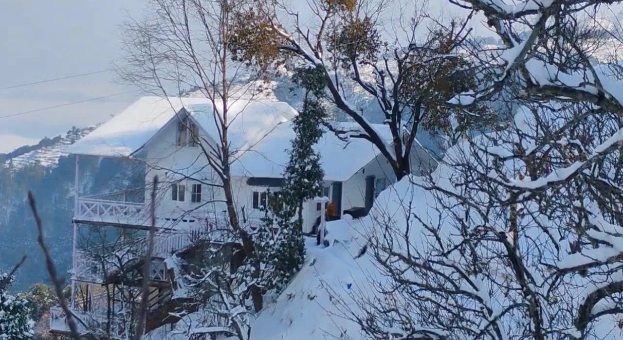 Namah Stay Himalayas cottage and orchard covered in snow in winter